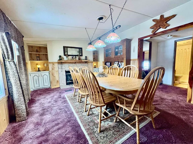 a spacious bedroom with a bed and a chandelier