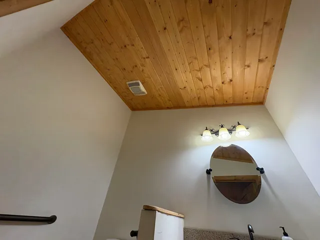 a living room with a table and chandelier
