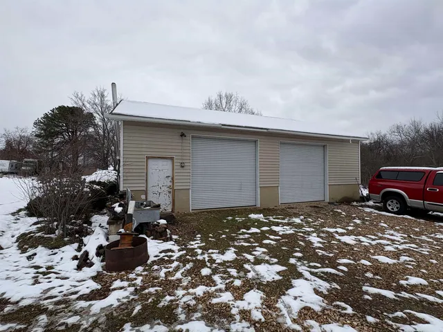 a front view of a house with a yard covered in snow