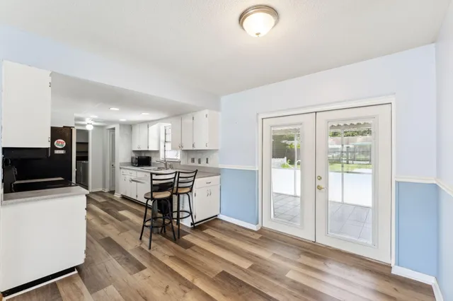 a view of a kitchen with refrigerator and window
