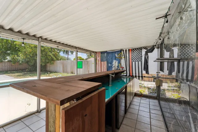 a open kitchen with a sink and wooden cabinets