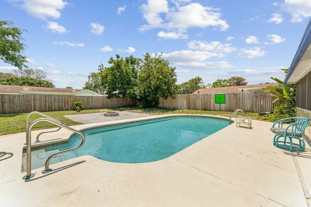 a view of a swimming pool with a backyard
