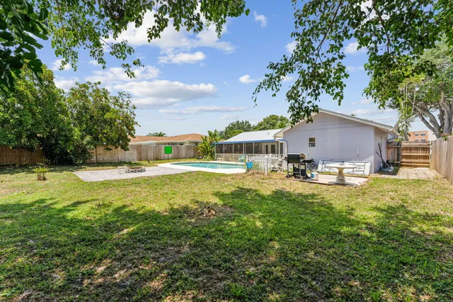 a house view with swimming pool in front of it