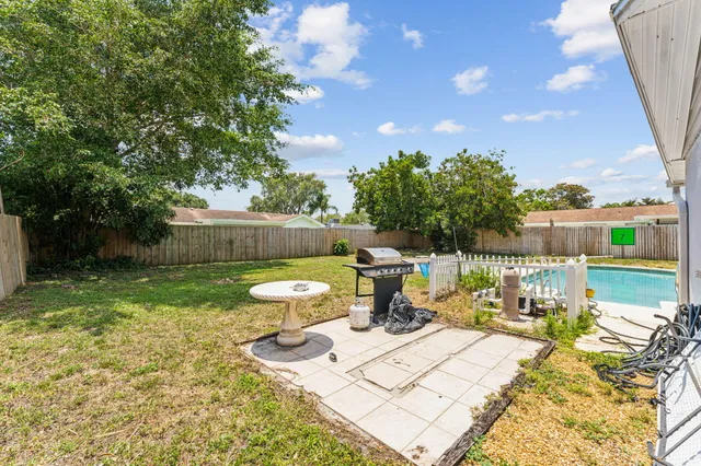 a view of a chair and tables in the backyard