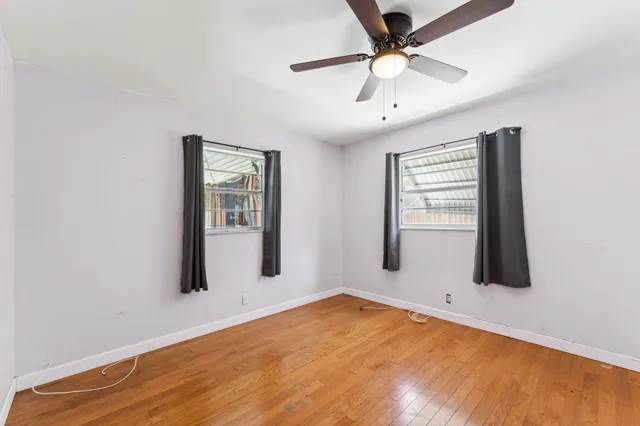 a view of empty room with ceiling fan