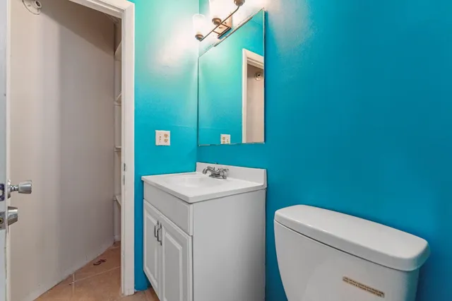 a bathroom with a sink a toilet and a mirror