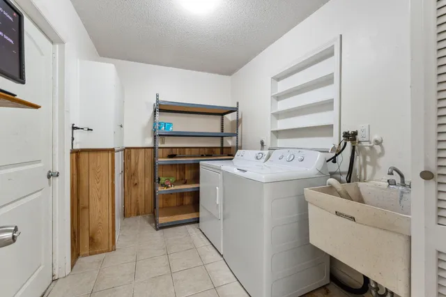 a utility room with cabinets dryer and washer
