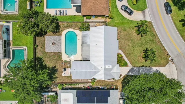 an aerial view of a house with a swimming pool