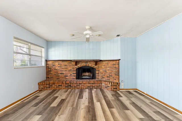 wooden floor in an empty room with a fireplace