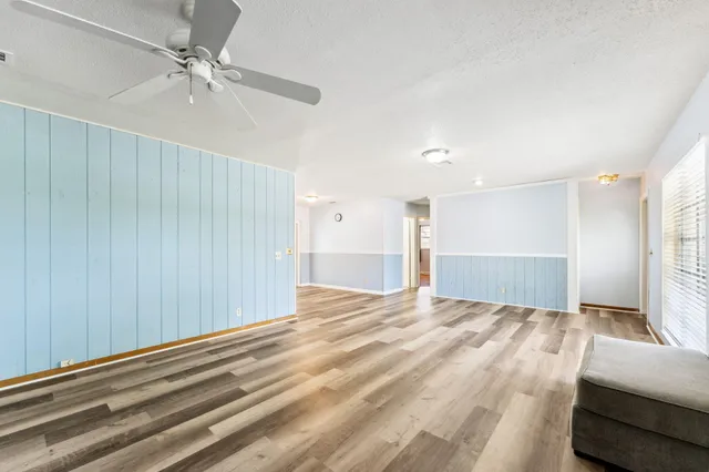 a view of a livingroom with a ceiling fan and window