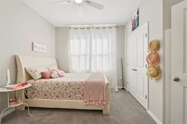 a bedroom with a bed and a flat tv screen on dresser