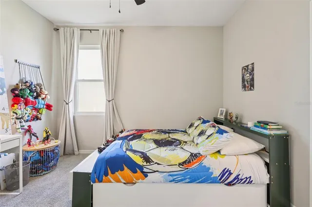 a bedroom with a bed and a painting on the wall