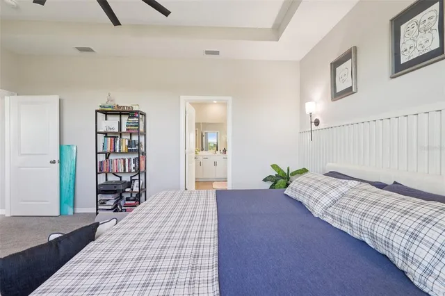 a living room with furniture a flat screen tv and a floor to ceiling window