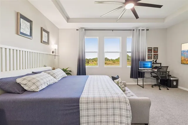 an aerial view of residential houses with outdoor space and ocean