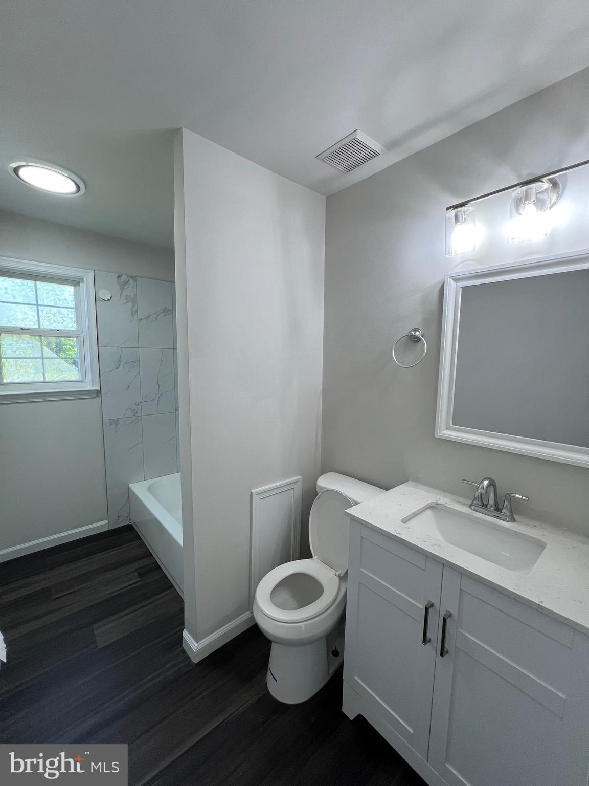 6604 Suitland Road Suitland, MD 20746 - Photo 23 of 27 a bathroom with a toilet a sink and mirror