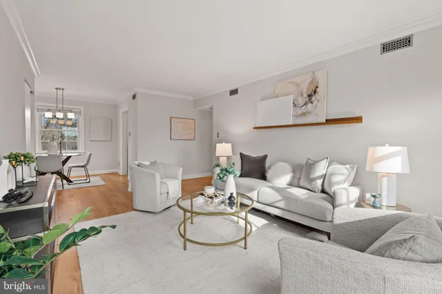 a living room with furniture a rug and a lamp