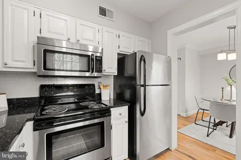 a kitchen with stainless steel appliances a stove a microwave and a refrigerator