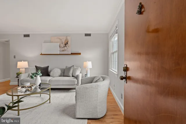 a living room with furniture and a wall painting