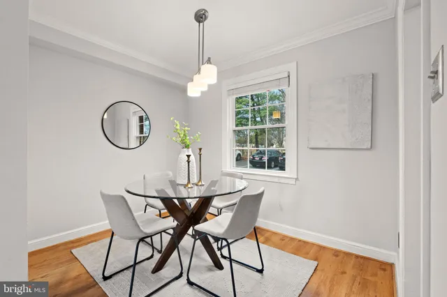 a view of a dining room with furniture window and wooden floor