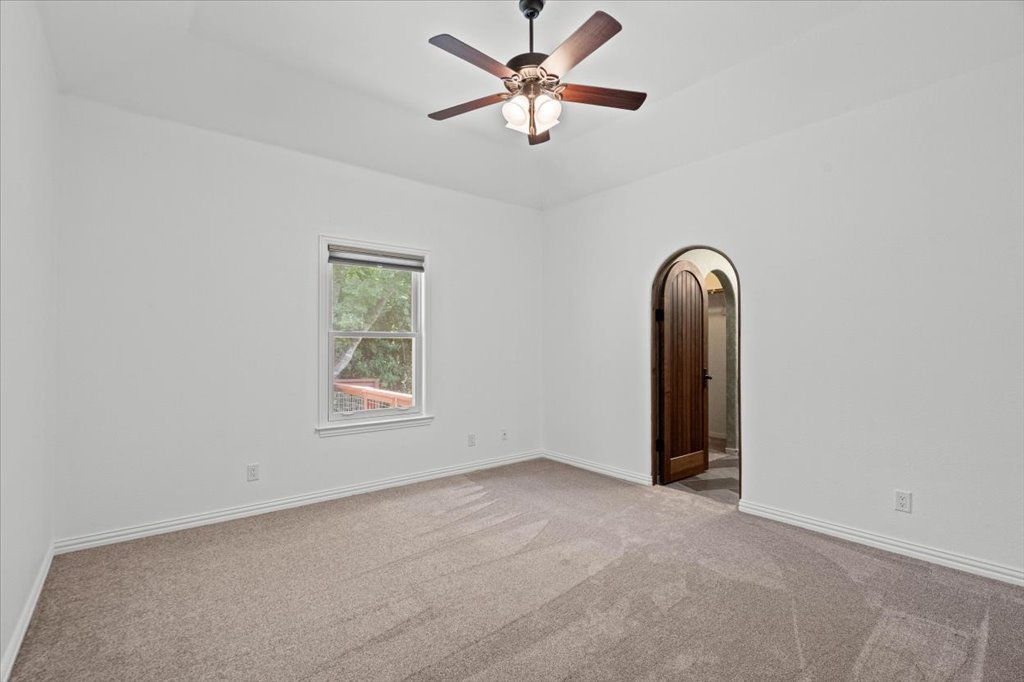 37 Pillow Road Austin, TX 78745 - Photo 9 of 18 A spacious, naturally illuminated room featuring a ceiling fan and plush carpet.