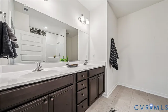 a bathroom with a double vanity sink and a mirror