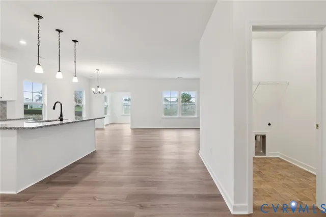 a view of a kitchen with a sink and wooden floor
