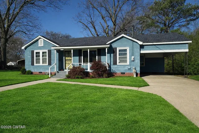 a front view of house with yard and green space