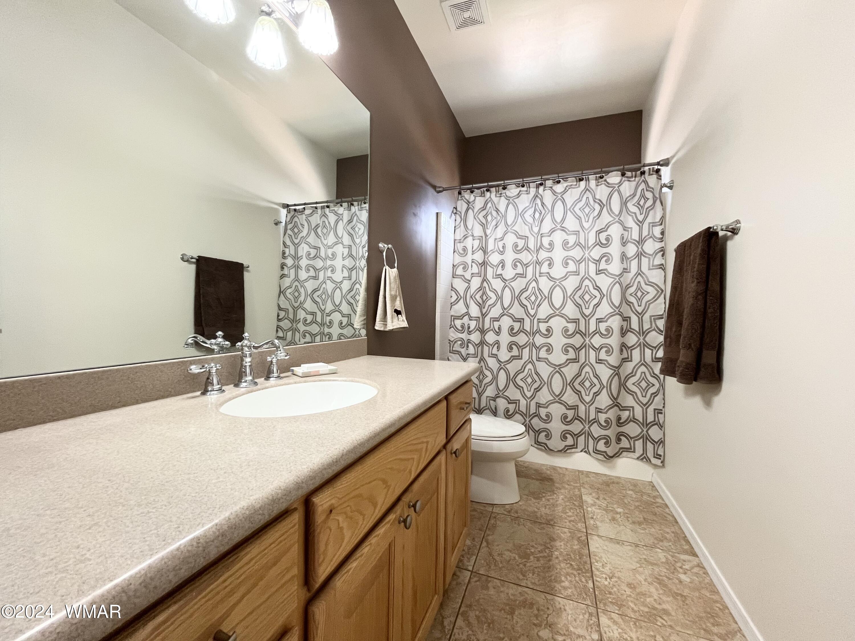 1968 West 7th S Street Snowflake, AZ 85937 - Photo 22 of 39 a bathroom with a sink toilet and shower