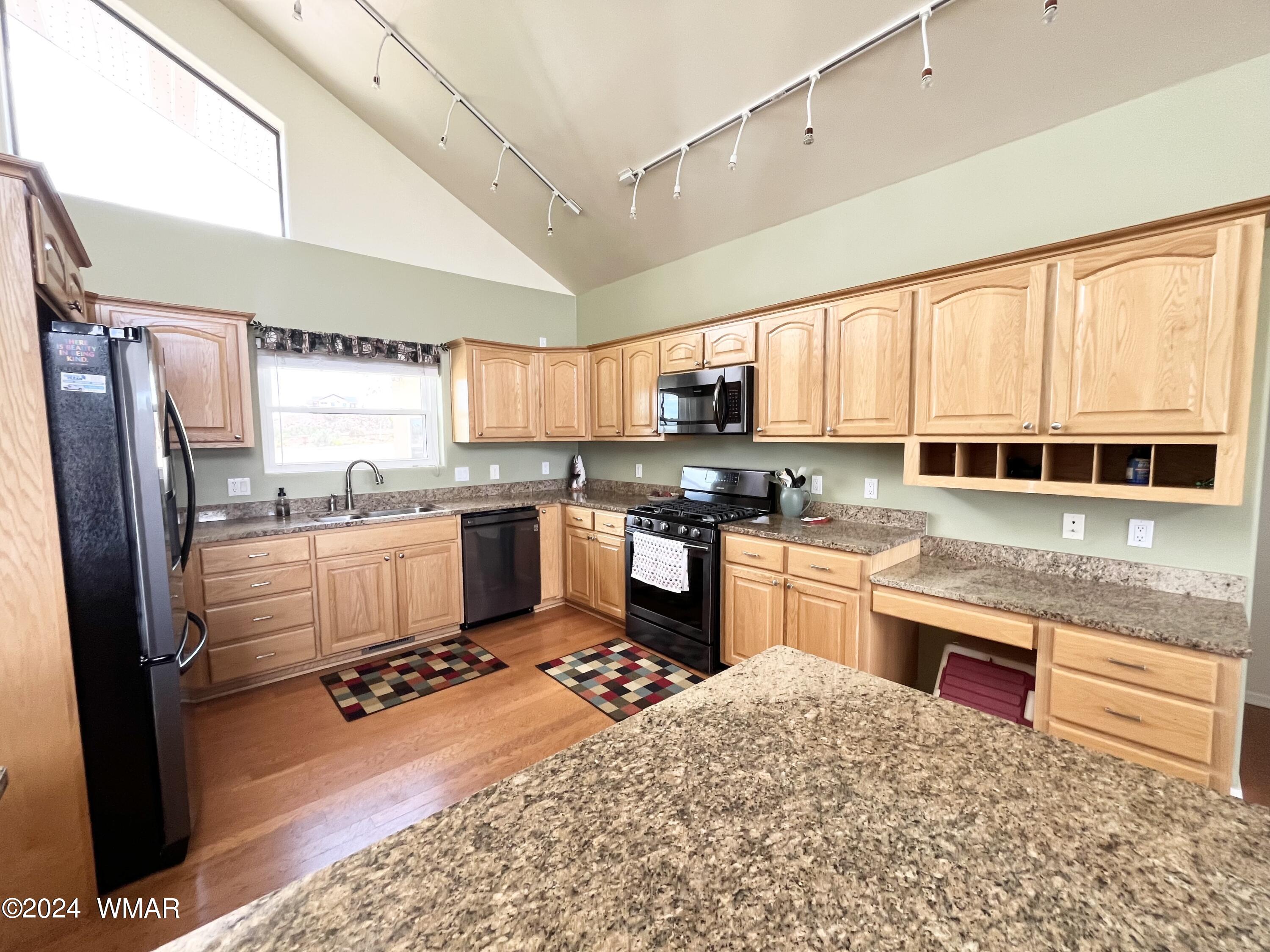 1968 West 7th S Street Snowflake, AZ 85937 - Photo 9 of 39 a kitchen with stainless steel appliances granite countertop a refrigerator sink and stove