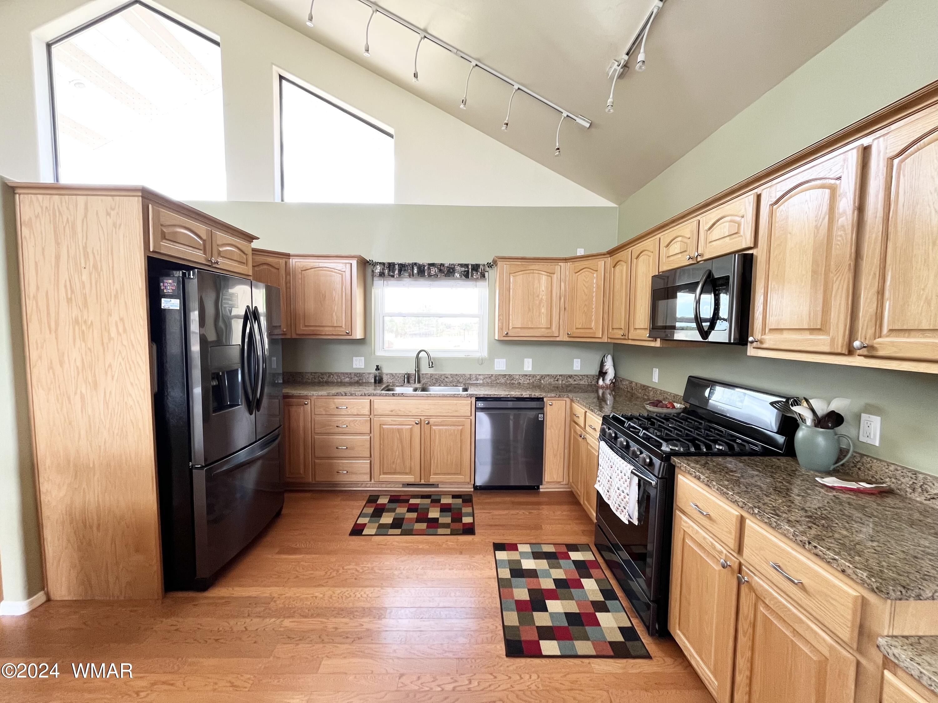 1968 West 7th S Street Snowflake, AZ 85937 - Photo 10 of 39 a kitchen with stainless steel appliances granite countertop a refrigerator a stove and a sink