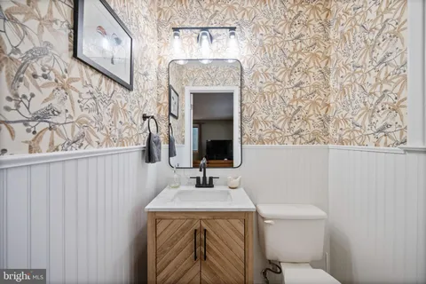 a bathroom with a toilet sink and mirror