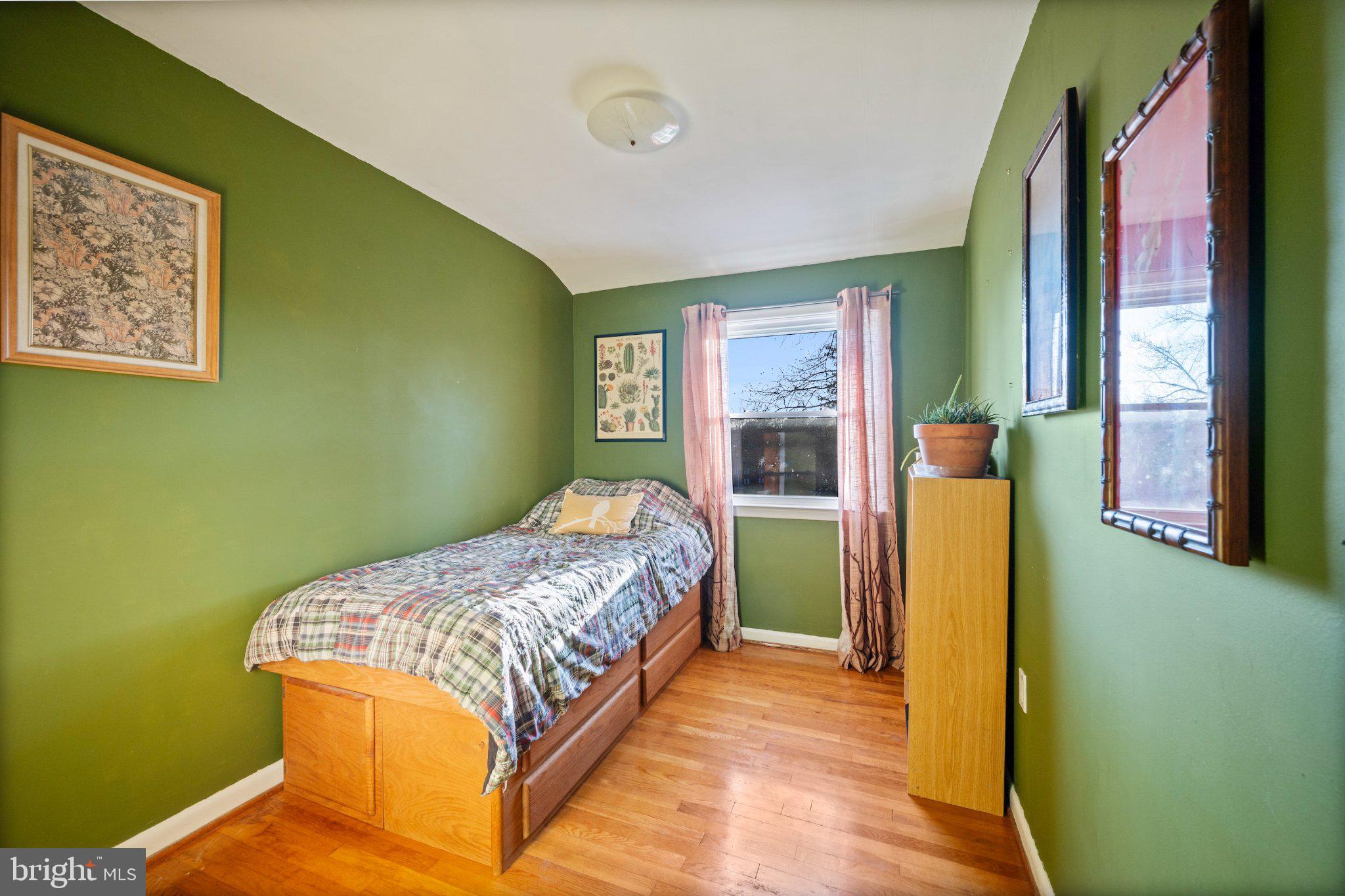 1311 Glenmont Road Baltimore, MD 21239 - Photo 23 of 49 Cozy green-hued bedroom retreat.