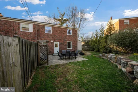 a view of backyard of house with outdoor seating and green space