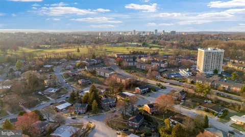 a view of a brick house with many windows next to a yard