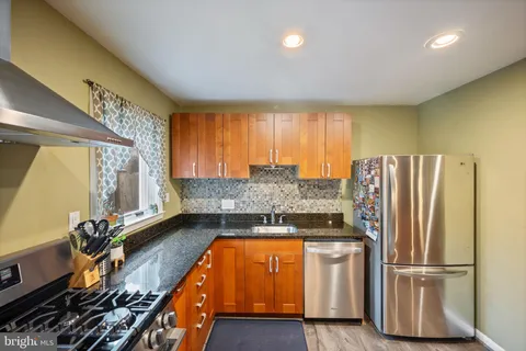 a kitchen with refrigerator and window