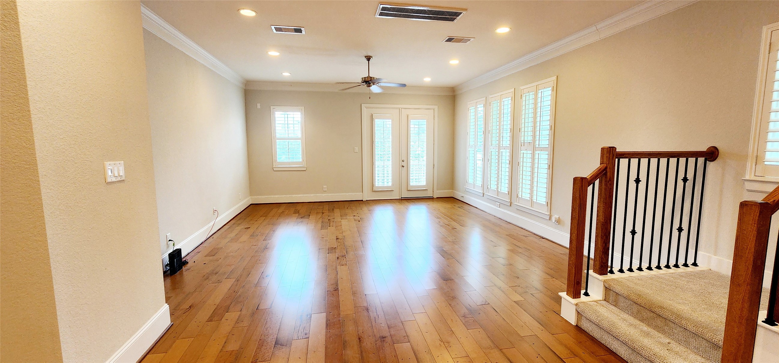 11 West Rafters Row The Woodlands, TX 77380 - Photo 16 of 31 an entryway of a room with wooden floor and windows