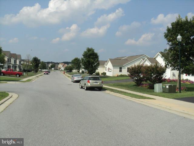 56 Peter Rabbit Drive Ranson, WV 25438 - Photo 4 of 28 a view of street with parked cars