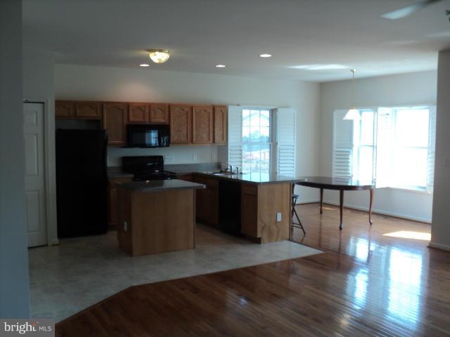 56 Peter Rabbit Drive Ranson, WV 25438 - Photo 8 of 28 a kitchen with stainless steel appliances granite countertop a refrigerator a sink a stove a microwave a counter space and cabinets