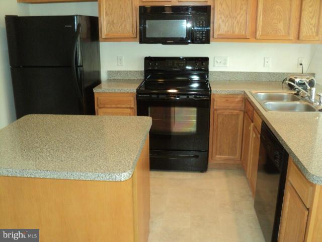 56 Peter Rabbit Drive Ranson, WV 25438 - Photo 9 of 28 a kitchen with a refrigerator and a sink