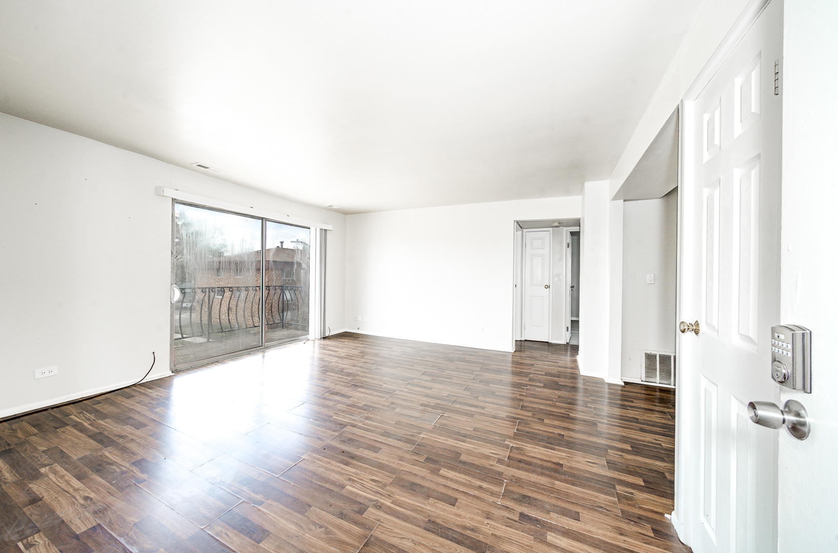 12741 South La Crosse Avenue, Unit 3A Alsip, IL 60803 - Photo 2 of 13 a view of an empty room with wooden floor and a window