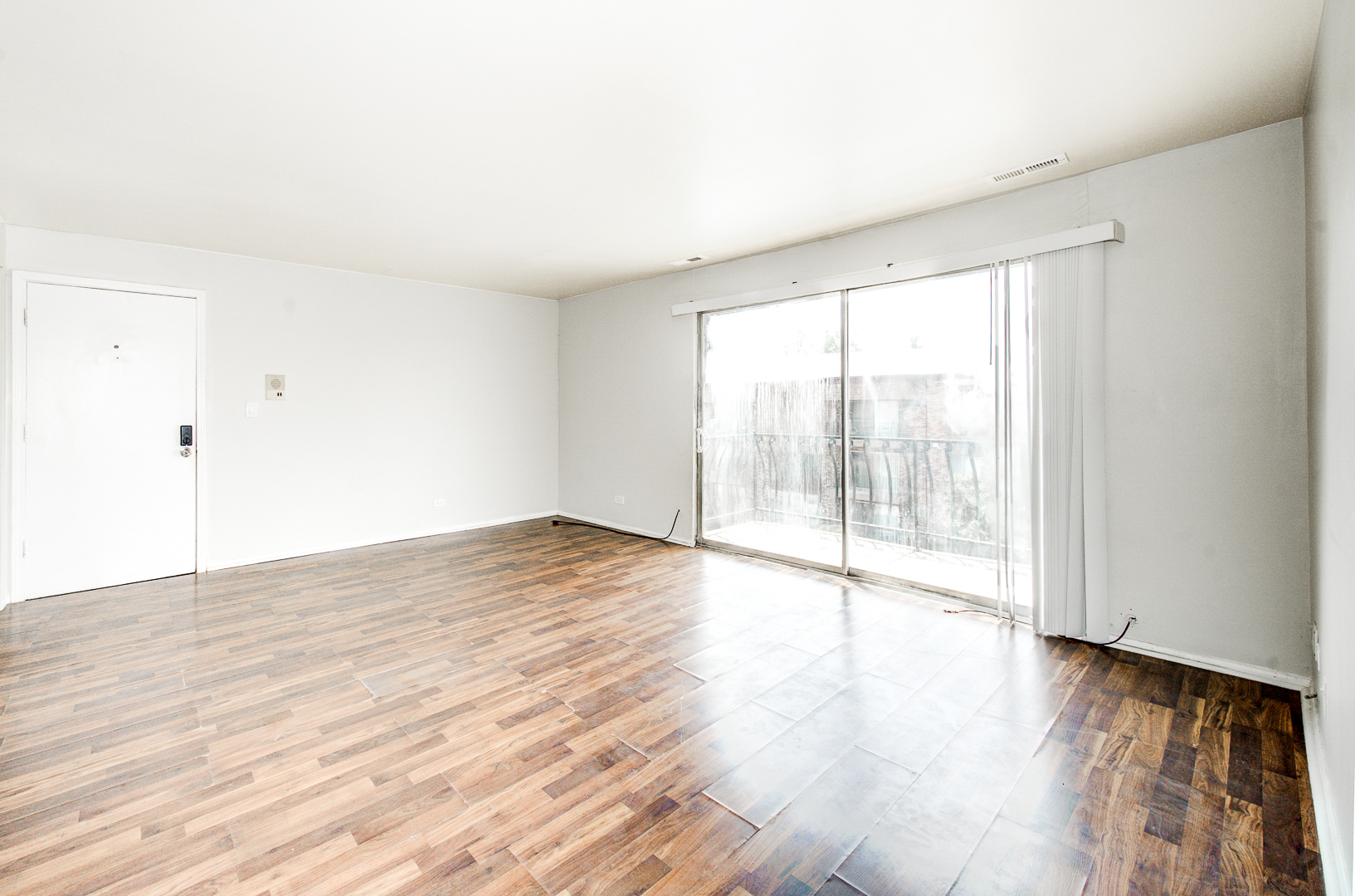 12741 South La Crosse Avenue, Unit 3A Alsip, IL 60803 - Photo 7 of 13 a view of an empty room with wooden floor and a window