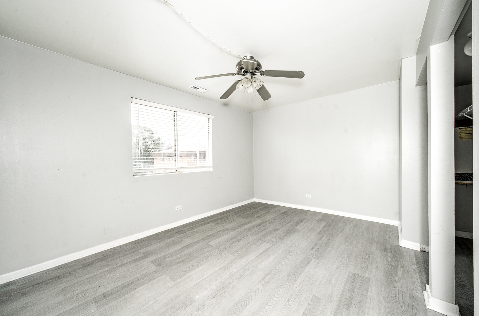 12741 South La Crosse Avenue, Unit 3A Alsip, IL 60803 - Photo 9 of 13 an empty room with wooden floor ceiling fan and windows