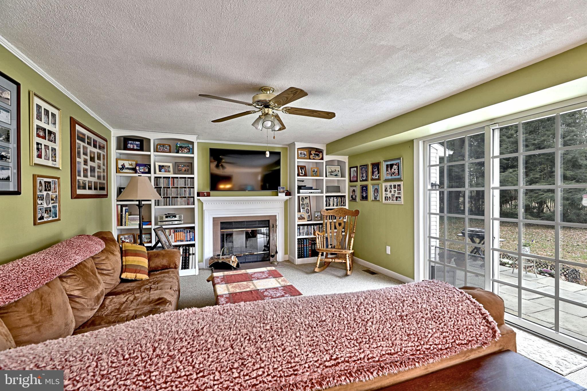 8 Meadow Drive Moorestown, NJ 08057 - Photo 13 of 36 a living room with furniture a fireplace and a flat screen tv