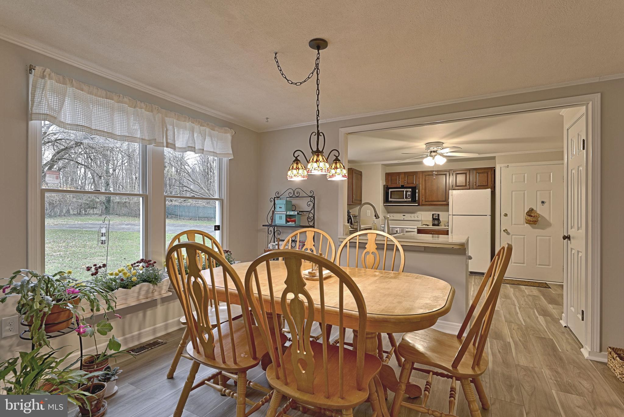 8 Meadow Drive Moorestown, NJ 08057 - Photo 15 of 36 a dining room with furniture a chandelier and wooden floor