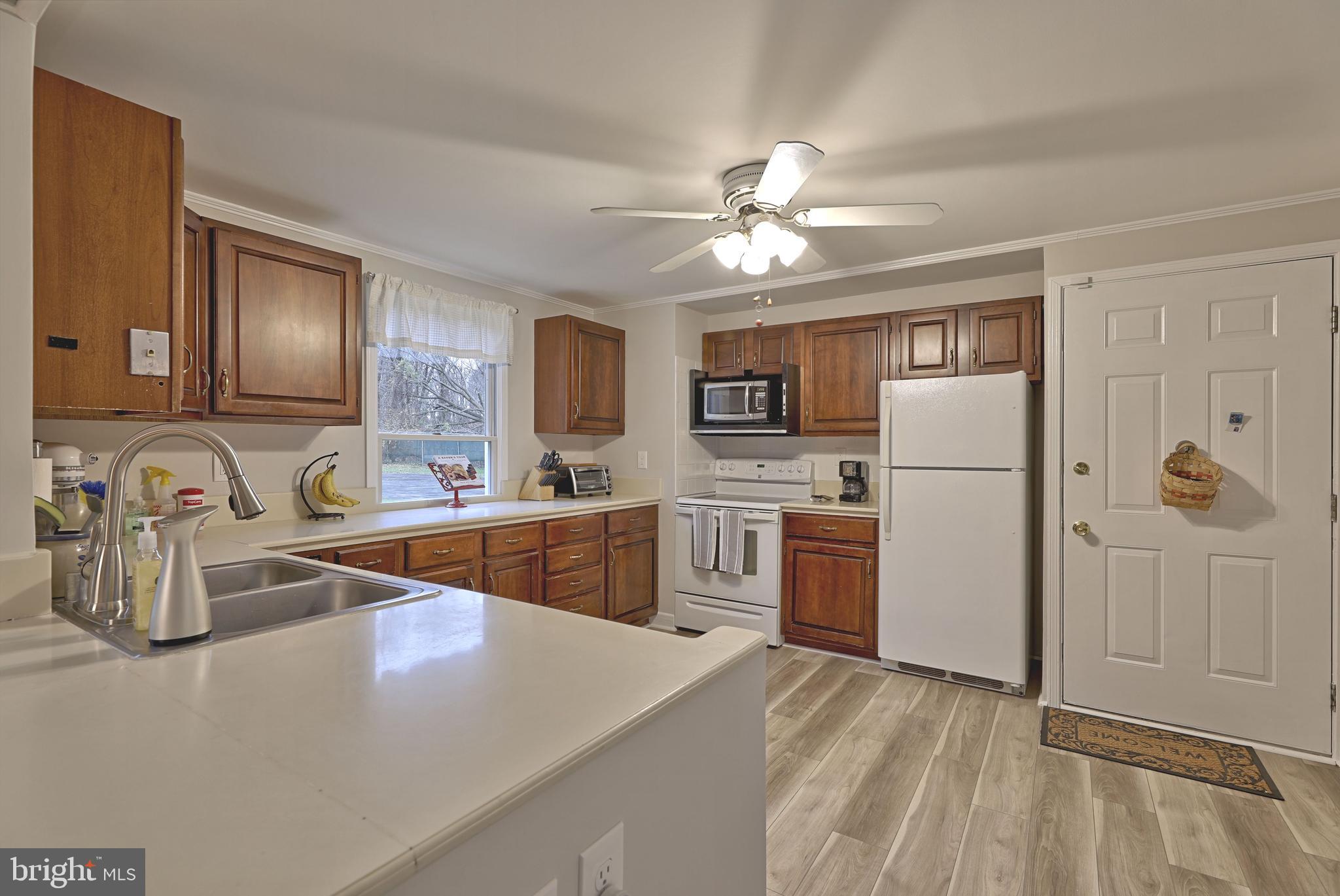 8 Meadow Drive Moorestown, NJ 08057 - Photo 16 of 36 a kitchen with refrigerator cabinets and wooden floor