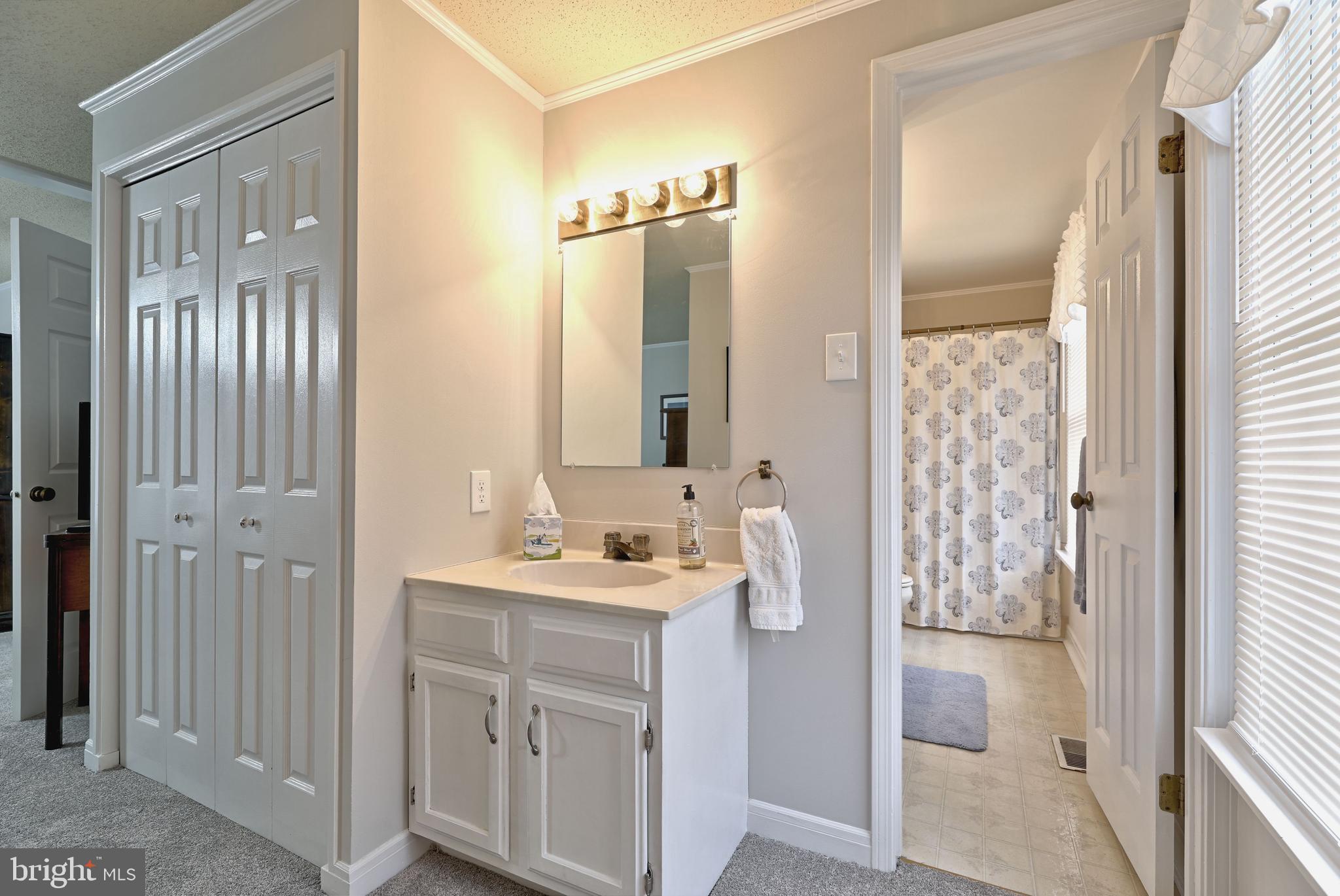 8 Meadow Drive Moorestown, NJ 08057 - Photo 21 of 36 a bathroom with a sink a mirror a vanity and a shower