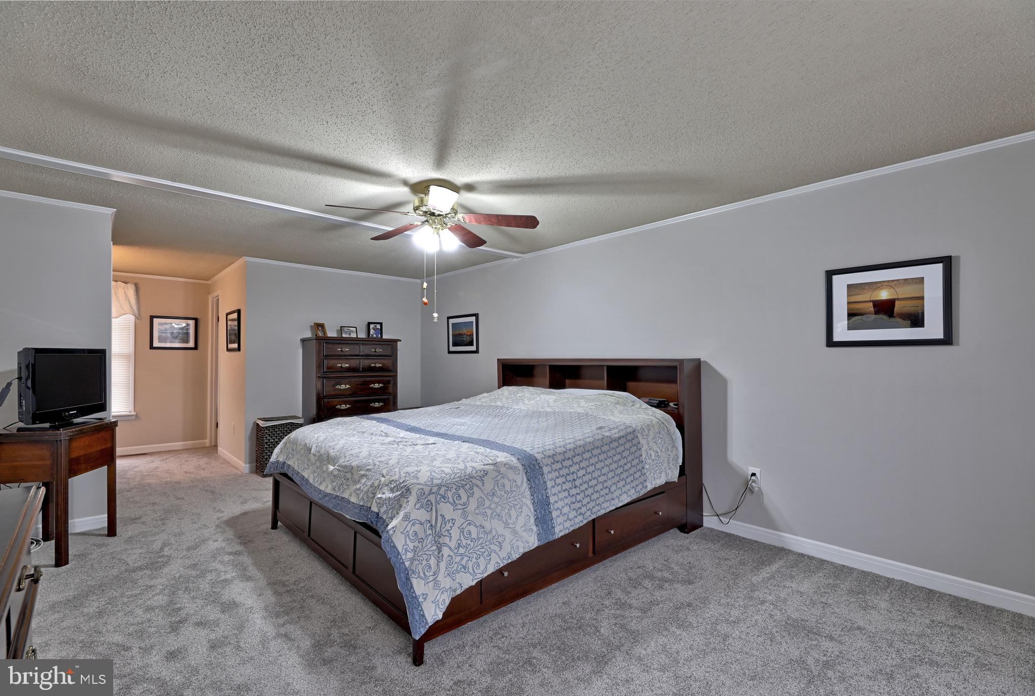 8 Meadow Drive Moorestown, NJ 08057 - Photo 23 of 36 a bedroom with a bed and a chandelier