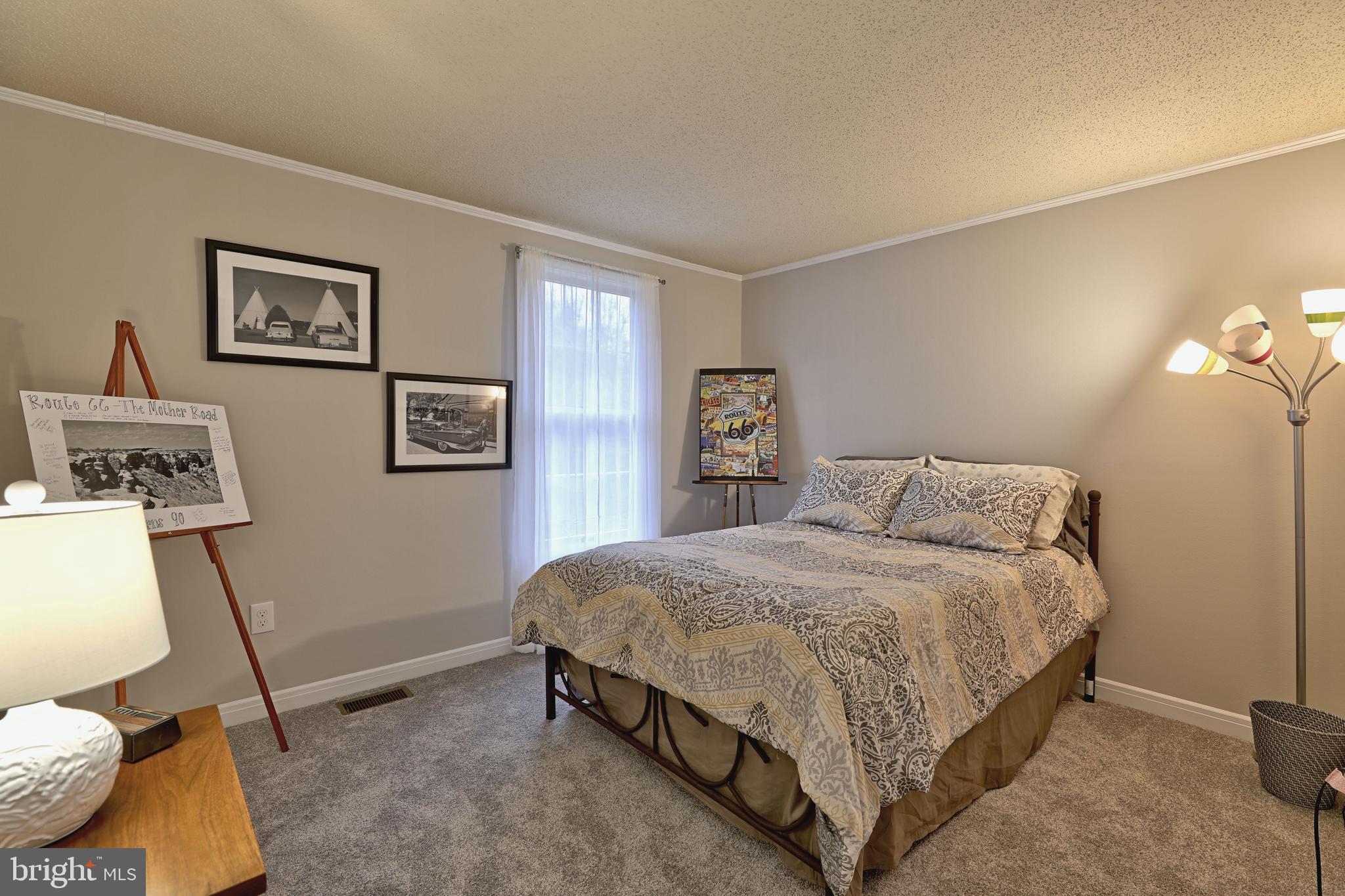 8 Meadow Drive Moorestown, NJ 08057 - Photo 26 of 36 a bedroom with a bed and painting on the wall
