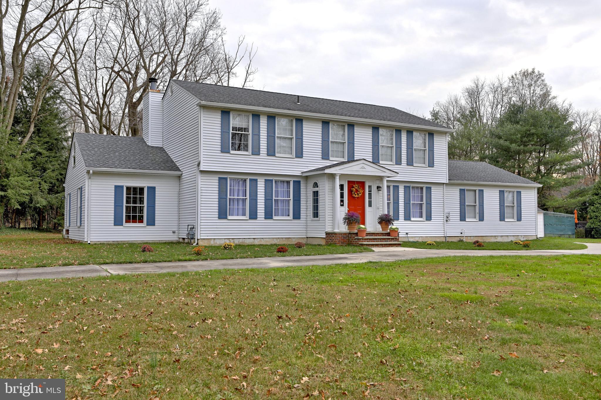 8 Meadow Drive Moorestown, NJ 08057 - Photo 4 of 36 a front view of a house with a garden