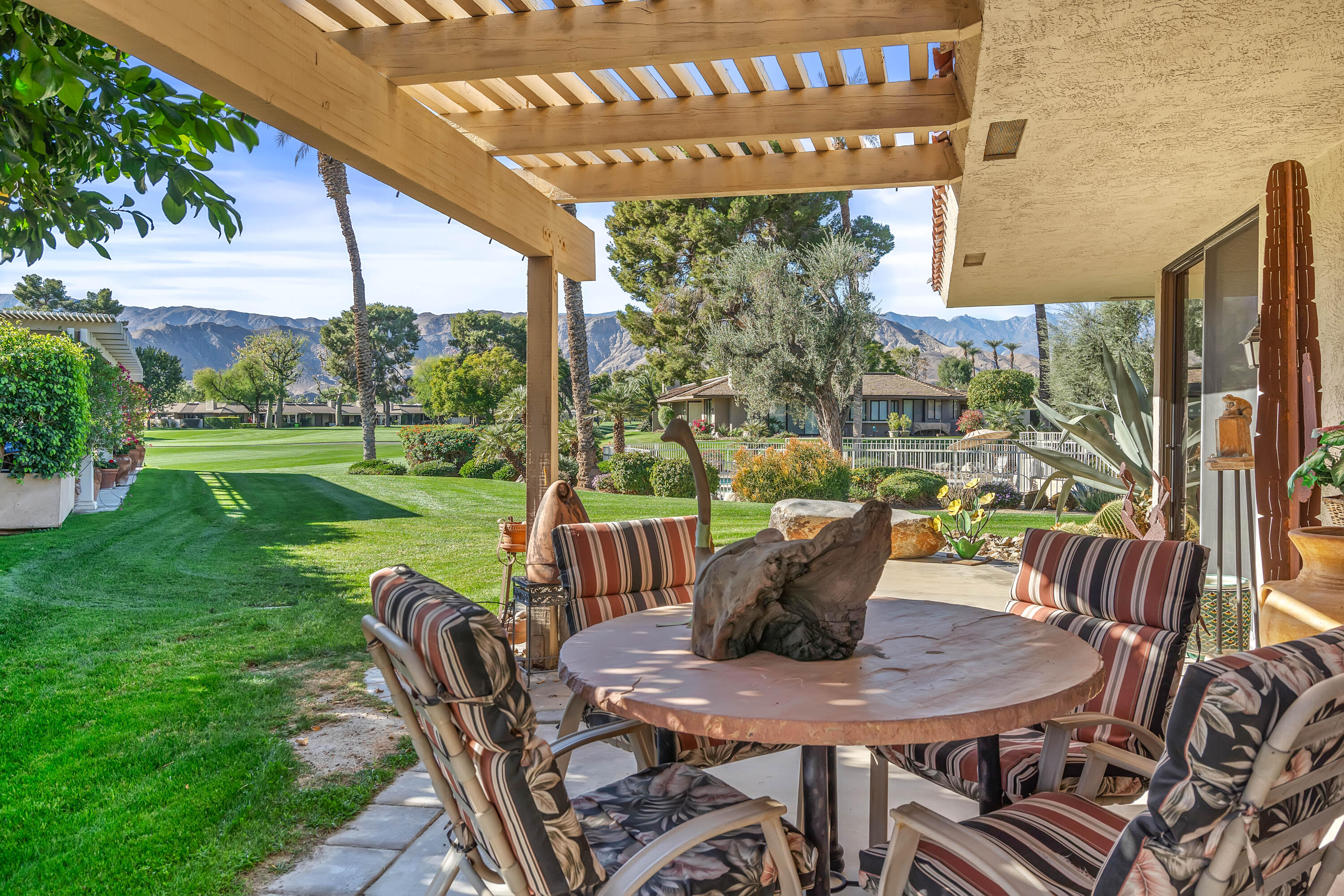 9 Swarthmore Court Rancho Mirage, CA 92270 - Photo 3 of 43 a view of an outdoor dining space with a table and chairs